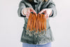 A woman holds many genuine leather wristlet straps