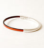 Camel Brown Thin Leather Bracelet for Women with Black Edge on a white table