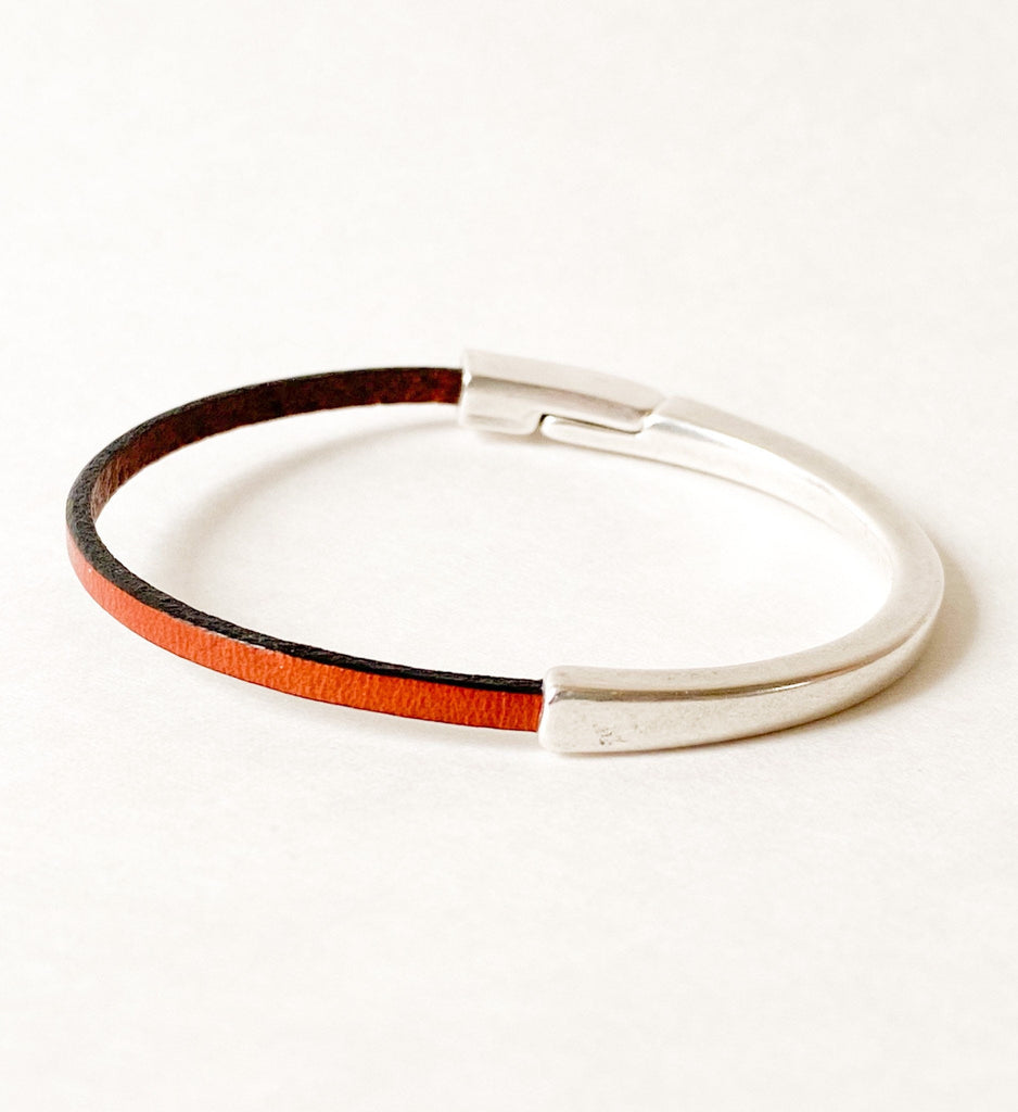Camel Brown Thin Leather Bracelet for Women with Black Edge on a white table