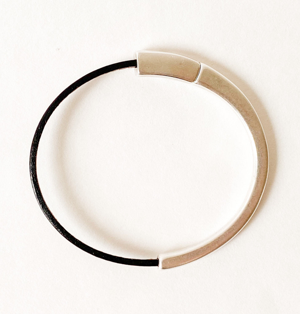 Camel Brown Thin Leather Bracelet for Women with Black Edge sits on a white table