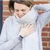 a woman wears a Gray Metallic Leather Bracelet with silver clasp along with gray sweater, scarf and gloves
