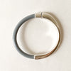 a thin gray leather bracelet with silver clasp