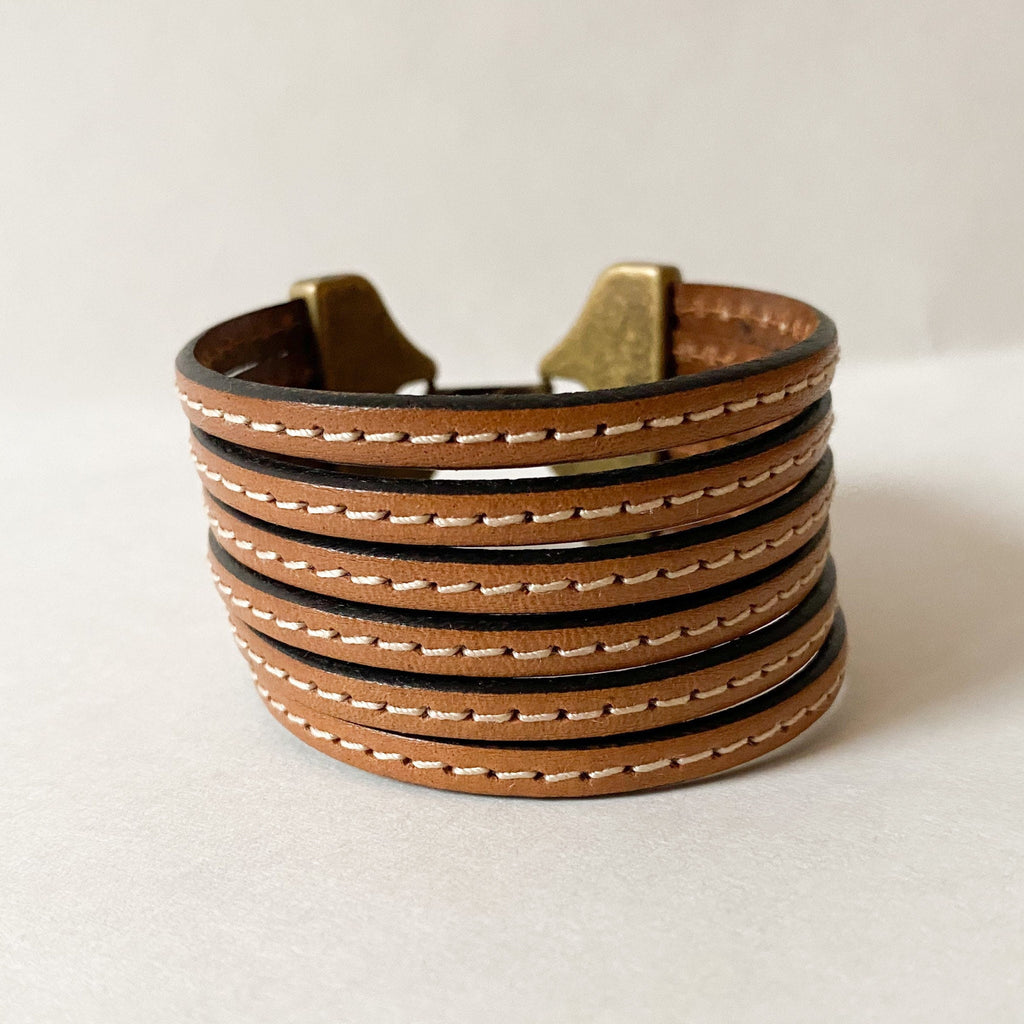 a multi strand cuff in camel brown with white stitching