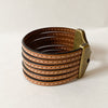 Camel Brown multi strand cuff on a white table