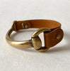 An antique brass and brown leather small snaffle bit bracelet