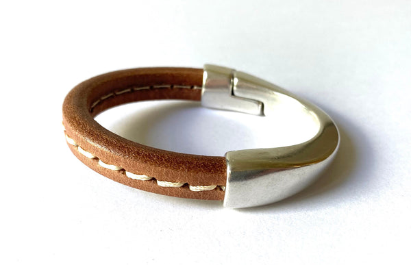 tan leather bracelet with white stitching and silver magnetic clasp